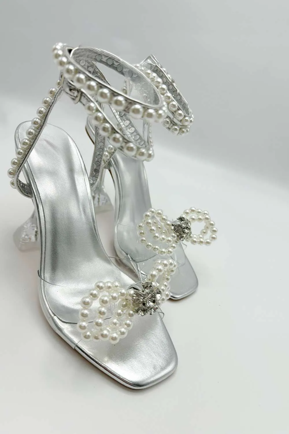 Pearlie Perspex Faux Pearl Bow Detail Heeled Sandals in Silver