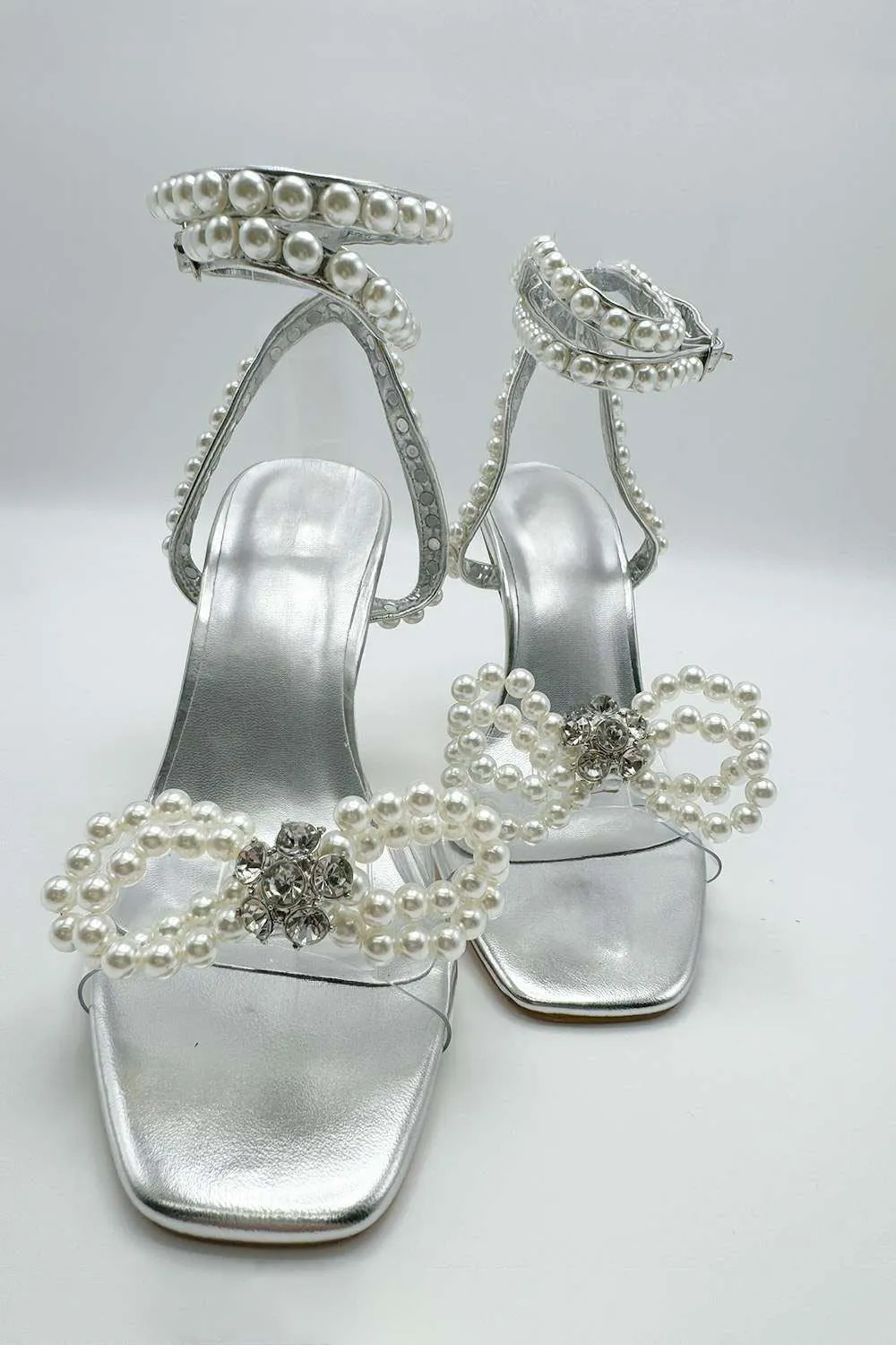 Pearlie Perspex Faux Pearl Bow Detail Heeled Sandals in Silver